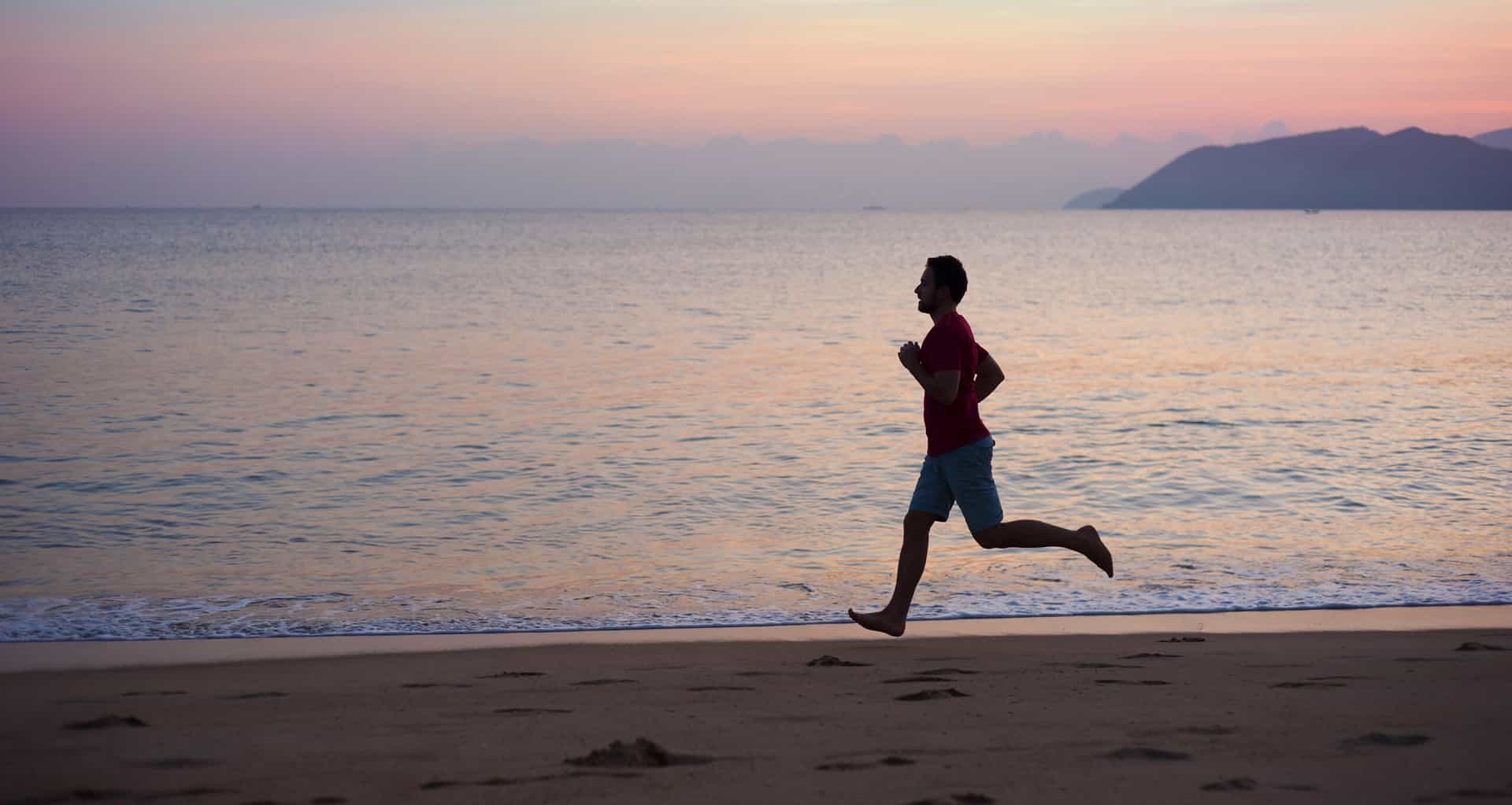Exercícios cardiorrespiratórios na prevenção do câncer – man running on the beach 2021 08 26 12 08 05 utc 1