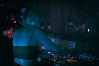 a woman in a bra top djing at a party
